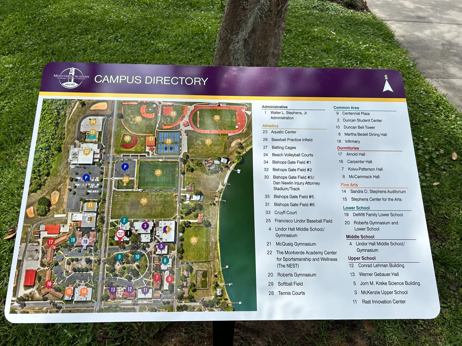 Completed campus wayfinding directory sign at a private academy, with aerial map overlay