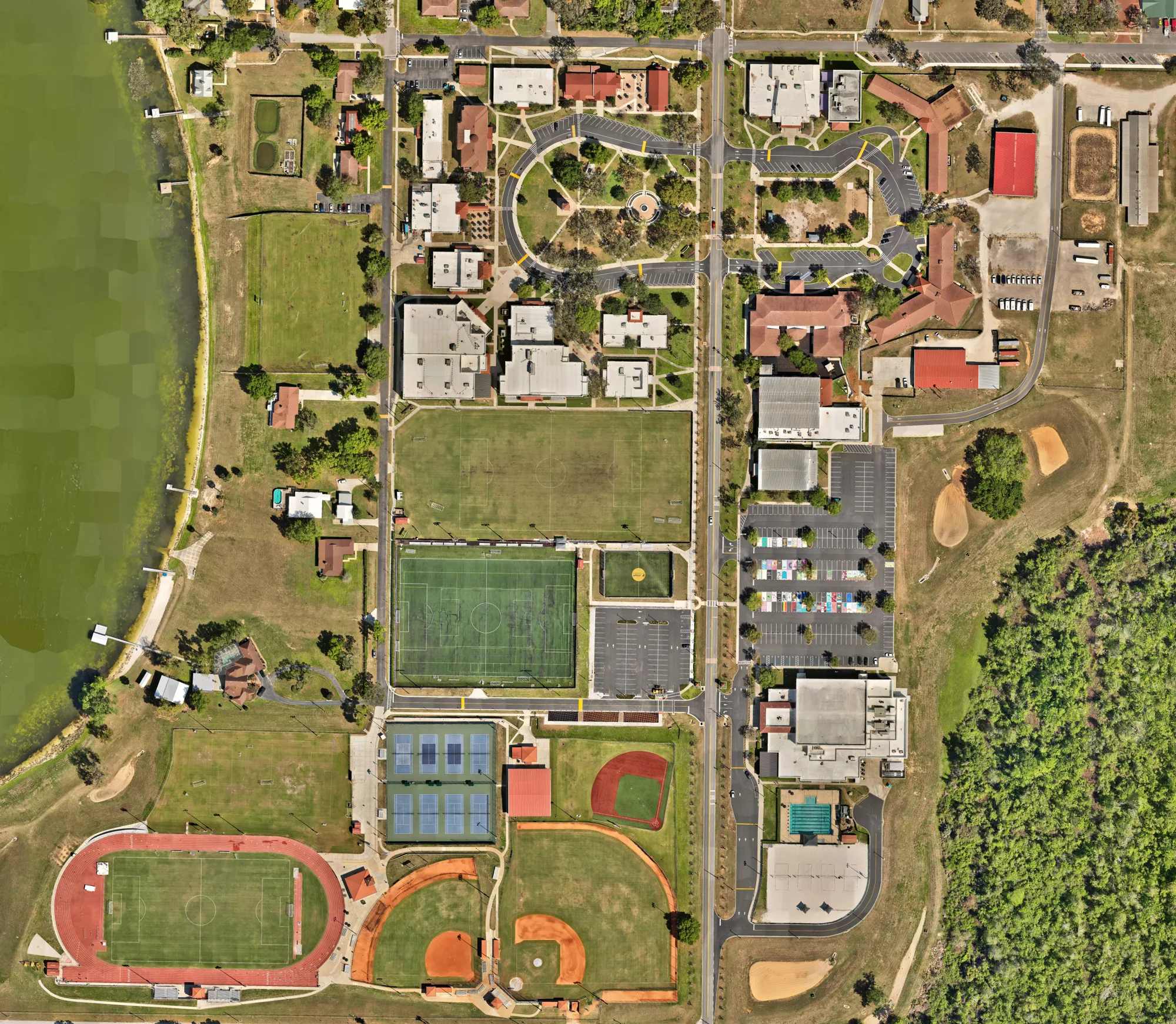 Full top-down orthomosaic of the Montverde Academy campus showing the academic core, athletic facilities, dormitories, and the surrounding landscape in a single stitched aerial image