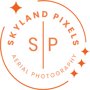 Skyland Pixels logo: aerial icon with construction orange on transparent background